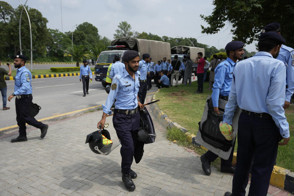 Police officers arrive to ensure security at the Islamabad High Court in Islamabad, Pakistan, Thursday, Aug. 24, 2023. A court in Pakistan's capital is likely to issue a crucial ruling Thursday on an appeal from the country's imprisoned former Prime Minister Imran Khan against his recent conviction and three-year sentence in a graft case, one of his lawyers said. (AP Photo/Anjum Naveed)