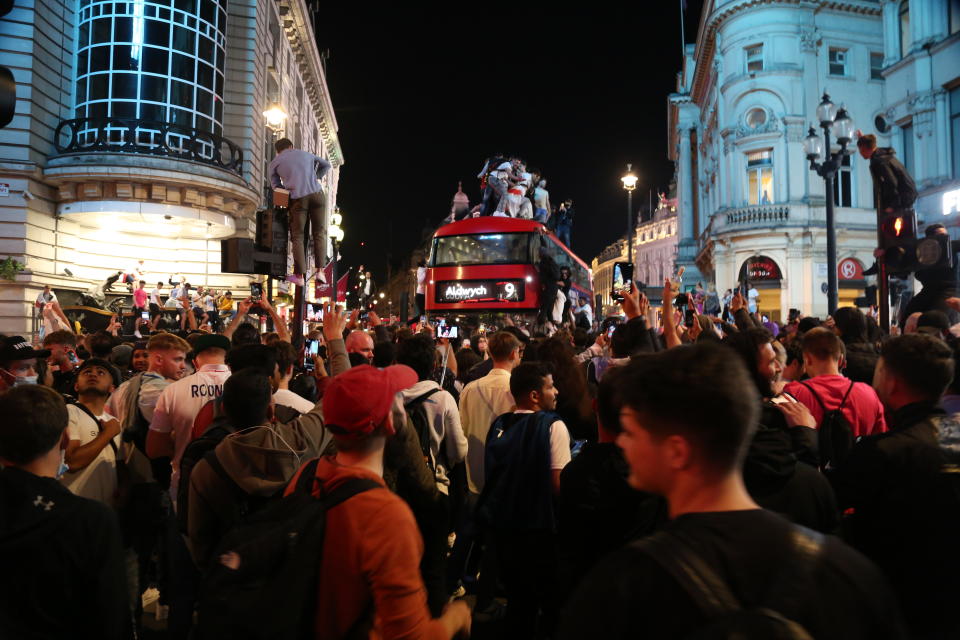 Fans scale a bus in London's Piccadilly Circus in the aftermath of Wednesday night's win. 