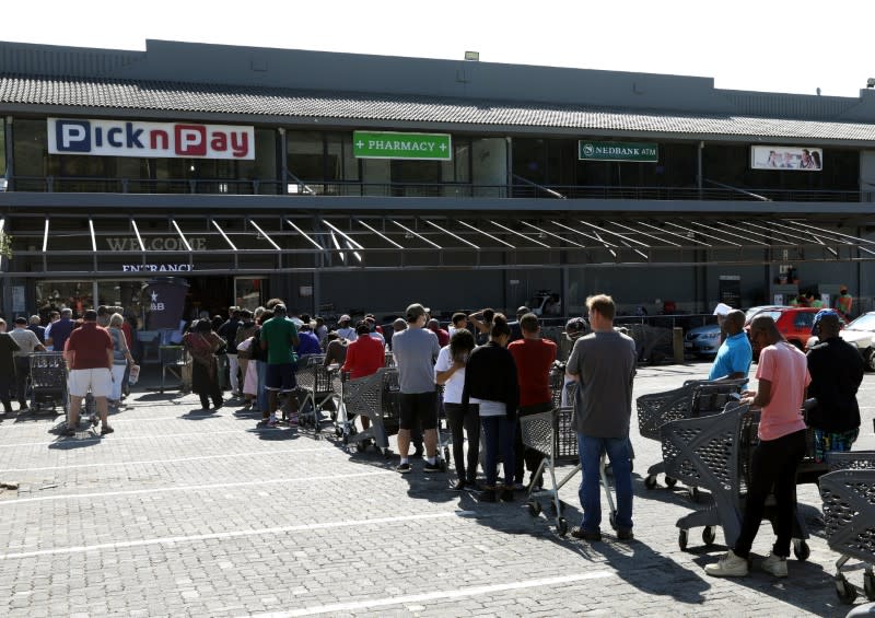 Shoppers queue to stock up on groceries at a Pick n Pay store