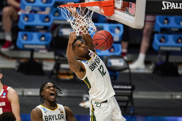 Baylor's Davion Mitchell (45) reacts as Jared Butler (12) gets a dunk against Wisconsin in the first half of a second-round game in the NCAA men's college basketball tournament at Hinkle Fieldhouse in Indianapolis, Sunday, March 21, 2021. (AP Photo/Michael Conroy)