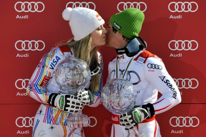 Overall World Cup winners US Lindsey Vonn (L) and Austria's Marcel Hirscher kisses each other as they pose with their World Cup crystal globes at the FIS Alpine Skiing World Cup finals in Schladming on March 18, 2012. AFP PHOTO / FABRICE COFFRINI