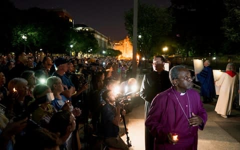 The Most Rev Michael Curry, right, takes part in a candlelight vigil outside the White House - Credit: Andrew Harnik/AP