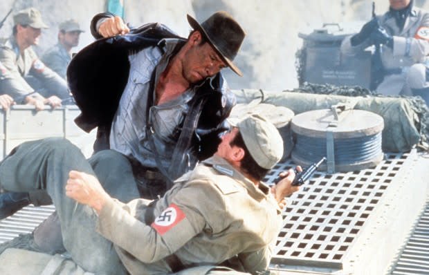 Harrison Ford as Indiana Jones punching a Nazi in "Indiana Jones and the Temple of Doom"<p><a href="https://www.gettyimages.com/detail/news-photo/harrison-ford-punches-a-man-in-a-scene-from-the-film-news-photo/168582619" rel="nofollow noopener" target="_blank" data-ylk="slk:Paramount/Getty Images;elm:context_link;itc:0;sec:content-canvas" class="link ">Paramount/Getty Images</a></p>