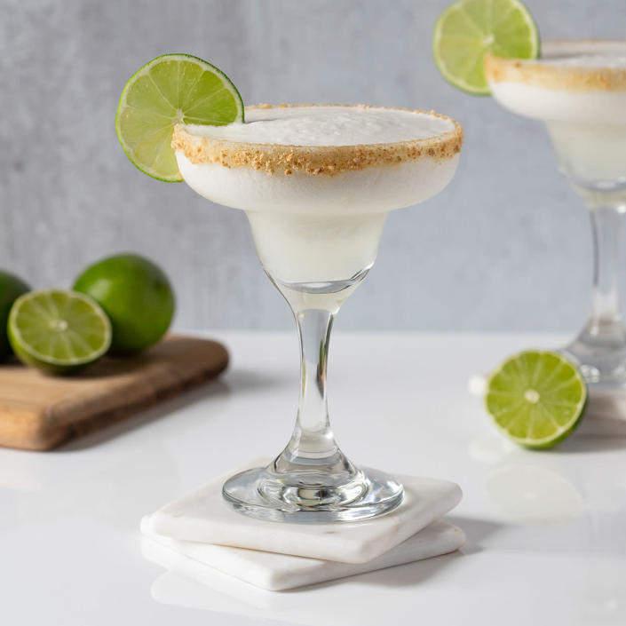 <p>This frozen margarita was inspired by the flavors of a cool and creamy Key lime pie. Whip up a batch of these easy frozen margaritas for Cinco de Mayo or anytime you want a sweet and refreshingly tart treat! Use Key limes--which have a wonderful floral aroma and flavor--if you can find them, but common limes work as well. Freshly squeezed juice will have the best flavor, but you can also find bottled Key lime juice--just be sure to buy unsweetened juice if you go for packaged juice. If you prefer a mocktail, simply replace the tequila with water. <a href="https://www.eatingwell.com/recipe/280011/frozen-key-lime-pie-margaritas/" rel="nofollow noopener" target="_blank" data-ylk="slk:View Recipe" class="link ">View Recipe</a></p>