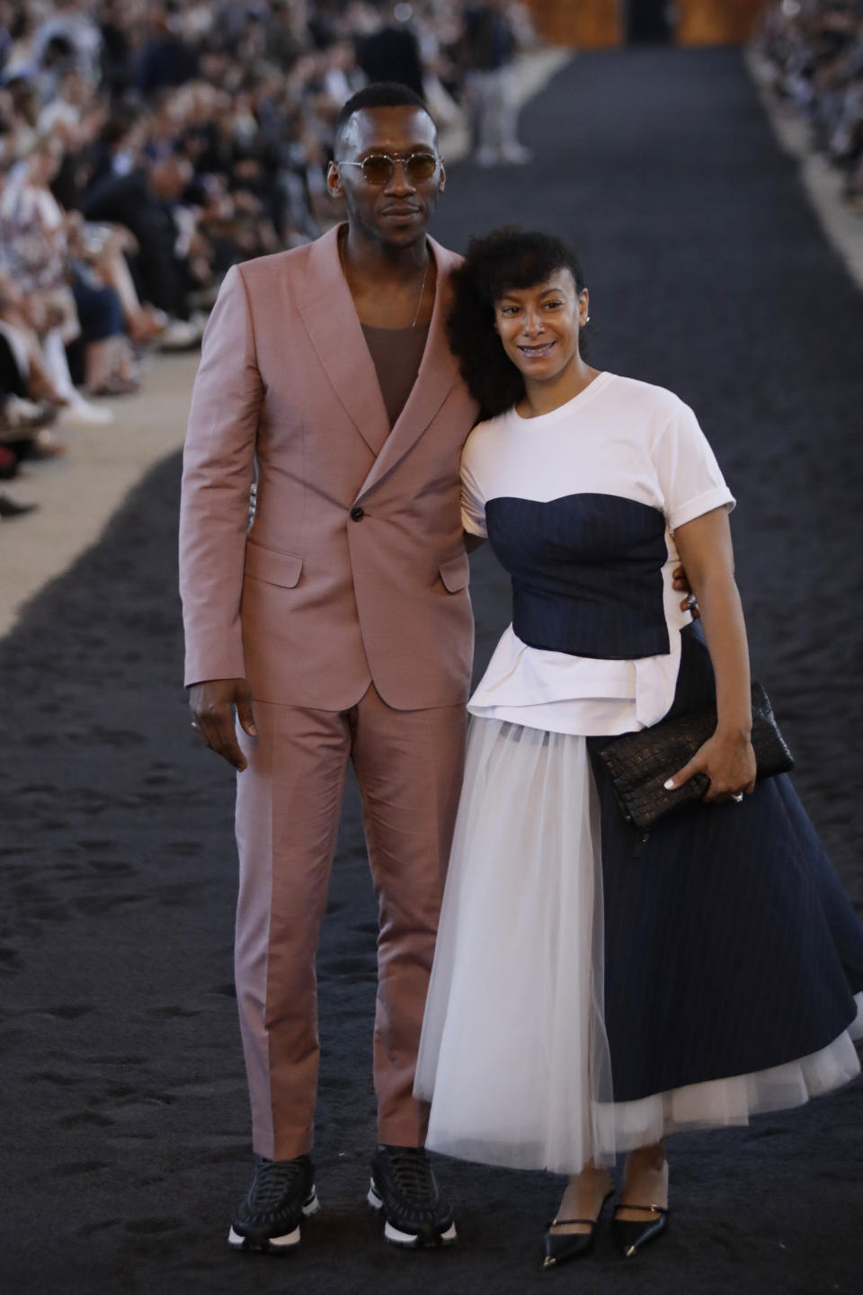 Actor Mahershala Ali, left, and his wife Amatus Sami-Karim arrive ahead of the Ermenegildo Zegna men's Spring-Summer 2020 collection, unveiled during the fashion week, in Milan, Italy, Friday, June 14, 2019. (AP Photo/Luca Bruno)