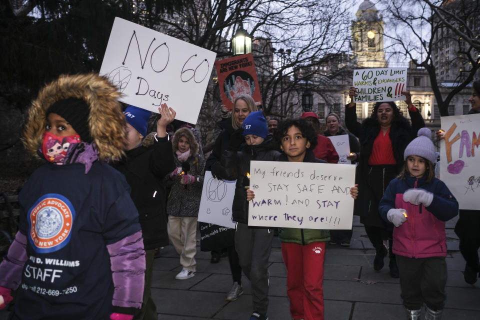 A small group of students, parents and immigrant advocates march near City Hall in New York, Tuesday, Dec. 19, 2023. The rally was held in response to an order New York Mayor Eric Adams issued in October limiting homeless migrants and their children to 60 days in city housing. (AP Photo/Seth Wenig)