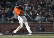 San Francisco Giants' Darin Ruf hits a solo home run against the San Diego Padres during the fifth inning of a baseball game in San Francisco, Friday, May 20, 2022. (AP Photo/Tony Avelar)