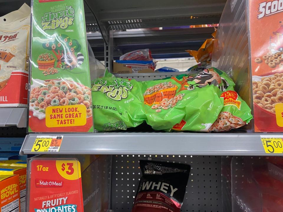 boxes and bags of cereal on the shelves at walmart