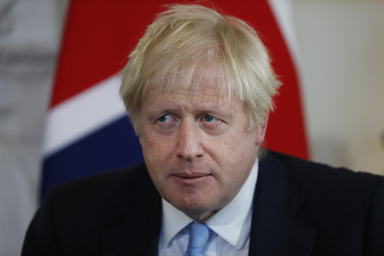 British Prime Minister Boris Johnson takes his seat as he waits for an official photo with Israel's Prime Minister Benjamin Netanyahu inside Downing Street in London, Thursday, Sept. 5, 2019. (AP Photo/Alastair Grant, Pool)