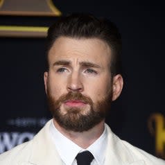 A closeup of Chris Evans in a light-colored suit