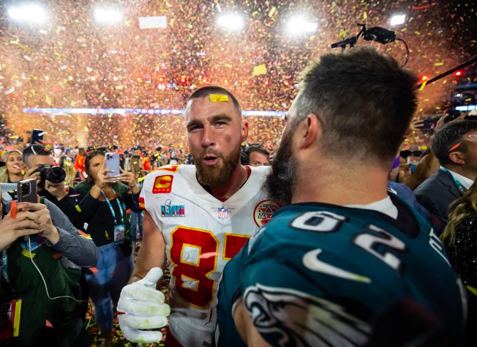 Kansas City Chiefs tight end Travis Kelce (87) talks with his brother Philadelphia Eagles center Jason Kelce (62) after Super Bowl 57 at State Farm Stadium.