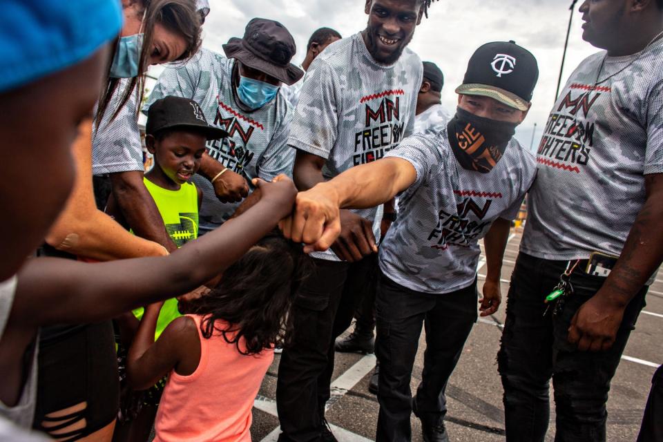 Members of the Minnesota Freedom Fighters connect with kids who came to their meet-and-greet.