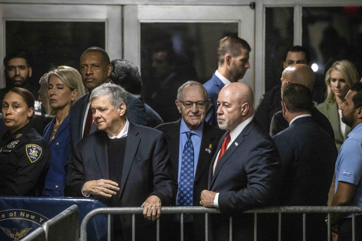 Attorney Alan Dershowitz, center left in blue shirt, and Bernard Kerik, center right, a former New York police commissioner, after former President Donald Trump spoke to reporters ahead of the start of the day