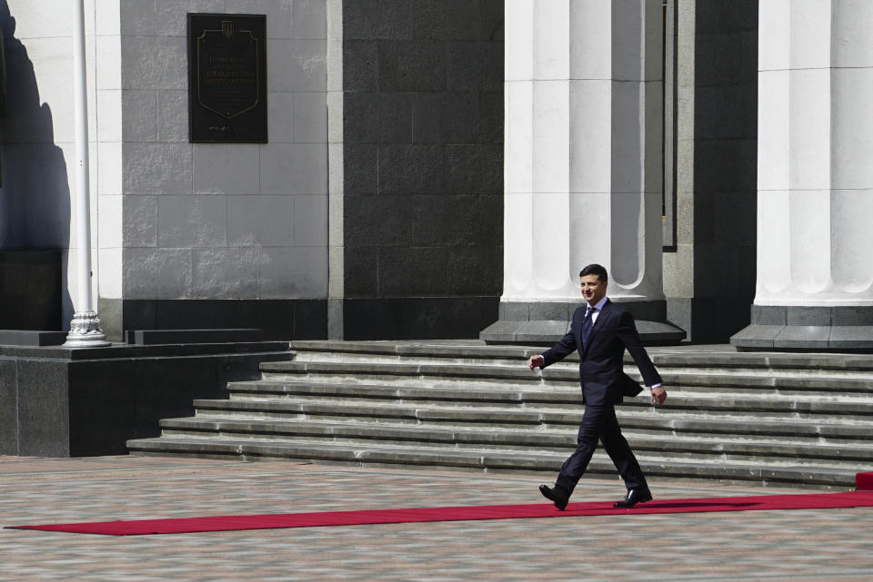 New Ukrainian President Volodymyr Zelenskiy, left, walks after inauguration ceremony in Kiev, Ukraine, Monday, May 20, 2019. Ukrainian TV star Volodymyr Zelenskiy was sworn in as the country's new president on Monday, promised to tackle the economic stagnation that has left millions in poverty and immediately disbanded the parliament that he has branded as a group only interested in self-enrichment. Even before he disbanded the Supreme Rada, which had been one of his campaign promises, the 41-year-old Zelenskiy had upended the traditions of Ukrainian politics. (AP Photo/Evgeniy Maloletka)