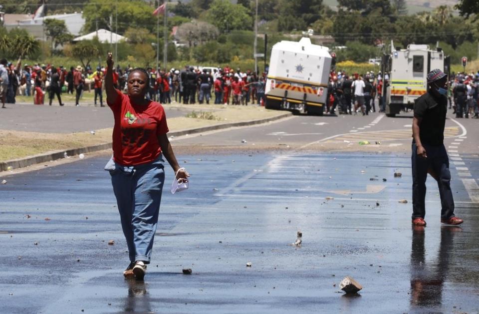 Members of the Economic Freedom Fighters (EFF) protest near the Brackenfell High school in Cape Town, South Africa, Friday, Nov. 20, 2020. (AP Photo/Nardus Engelbrecht)