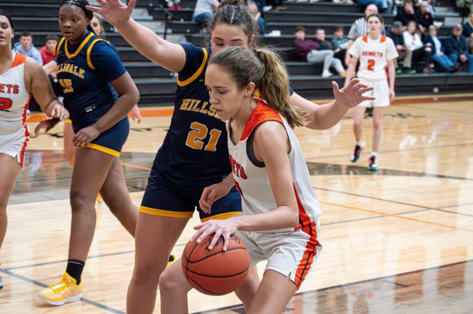 Jonesville freshman Kira Van Kampen (11) is pressured on the offensive end of the court by Hillsdale senior Karsyn Stebbins (21).