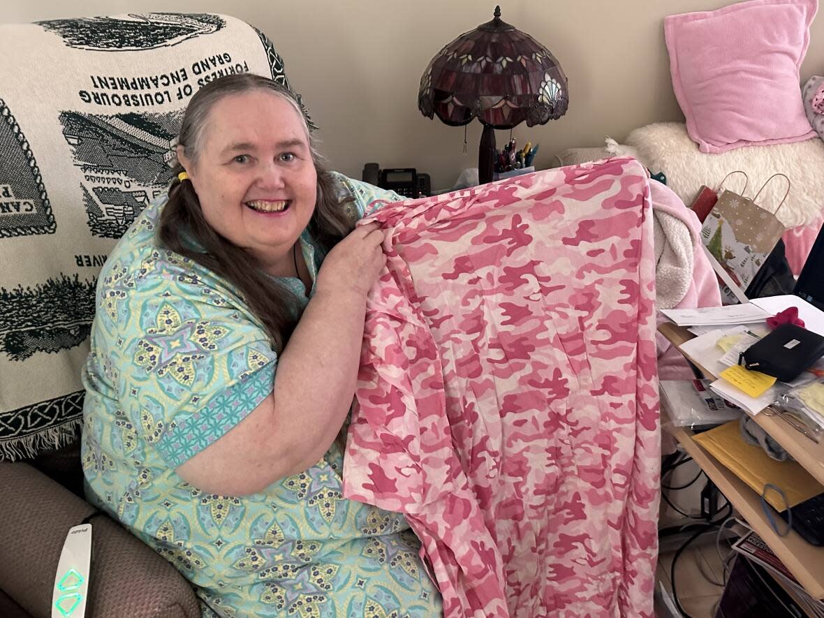 Yvonne Campbell of Glace Bay, N.S., says local hospitals have not had hospital gowns, also called johnny shirts, large enough to fit her, so she's made her own. (Holly Conners/CBC - image credit)