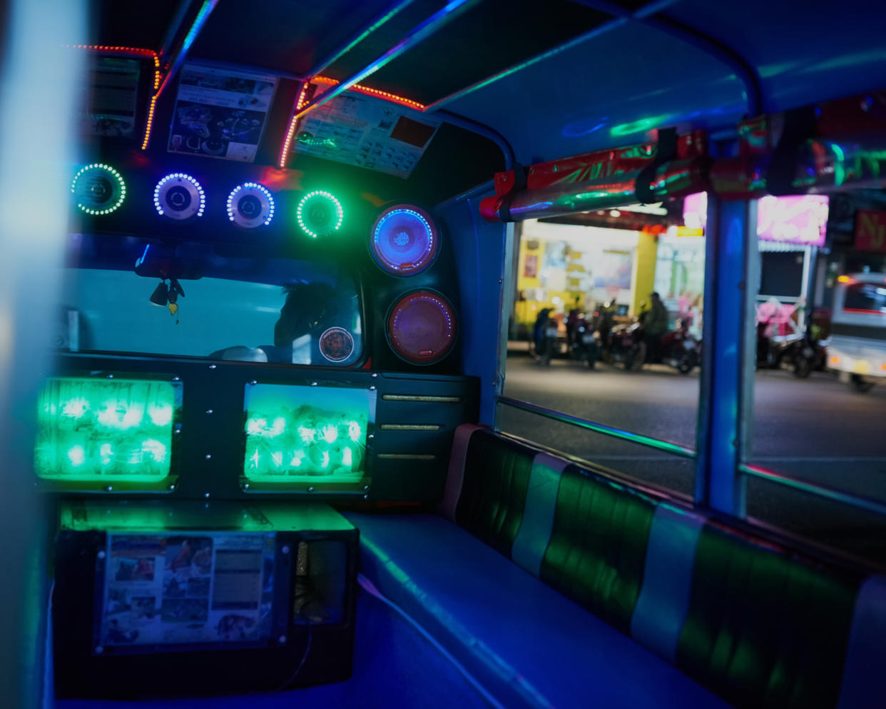 The interior of a bus fitted with neon lights. 