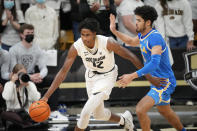 Colorado forward Jabari Walker, left, is defended by UCLA guard Johnny Juzang during the second half of an NCAA college basketball game Saturday, Jan. 22, 2022, in Boulder, Colo. UCLA won 71-65. (AP Photo/David Zalubowski)