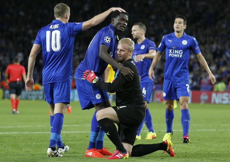 Leicester City's goalkeeper Kasper Schmeichel (C) celebrates the club's victory against Porto with teammates