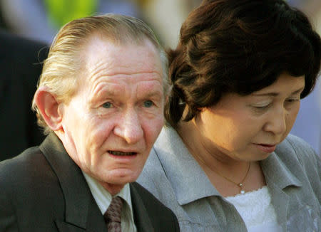 FILE PHOTO: Former U.S. army sergeant Charles Robert Jenkins is escorted by his Japanese wife Hitomi Soga as they arrive at Tokyo's Haneda airport July 18, 2004 after being reunited in Jakarta. REUTERS/Eriko Sugita/File Photo