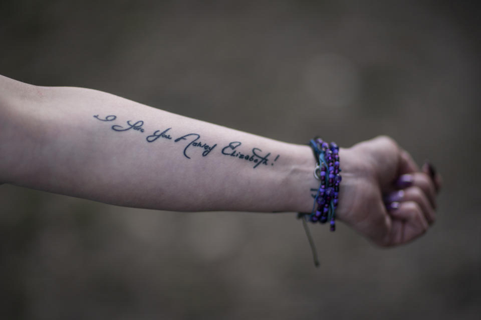 Ashley Ellis, 34, shows a tattoo of a handwritten note from her fiancé, Brandon Williams, on her arm, Tuesday, March 16, 2021, in Huntington, W.Va. Ellis started using drugs in college and has tried many times to stop using. She met the love of her life, Williams, when they were both in recovery. "He had the most beautiful soul of anyone I've ever known," she said. But shortly after their child was born, they both relapsed. Williams died of an overdose. Now she's determined to remain in recovery. "I think losing Brandon has been, quite possibly, what's going to save my life." (AP Photo/David Goldman)