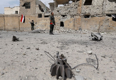 Soldiers loyal to Syria's President Bashar al-Assad forces are deployed at al-Qadam area near Yarmouk Palestinian camp in Damascus,Syria April 29,2018.REUTERS/ Omar Sanadiki