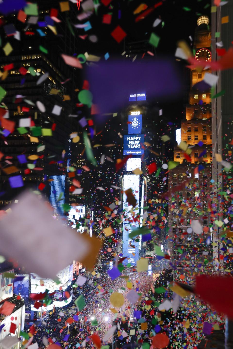 Confetti drops over the crowd as the clock strikes midnight during the New Year's celebration as seen from the New York Marriott Marquis in New York's Times Square, late Tuesday, Dec. 31, 2019. (AP Photo/Frank Franklin II)