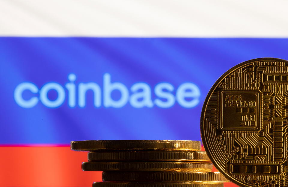 A representation of the cryptocurrency is seen in front of the Coinbase logo and the Russian flag in this illustration taken March 4, 2022. REUTERS/Dado Ruvic/Illustration