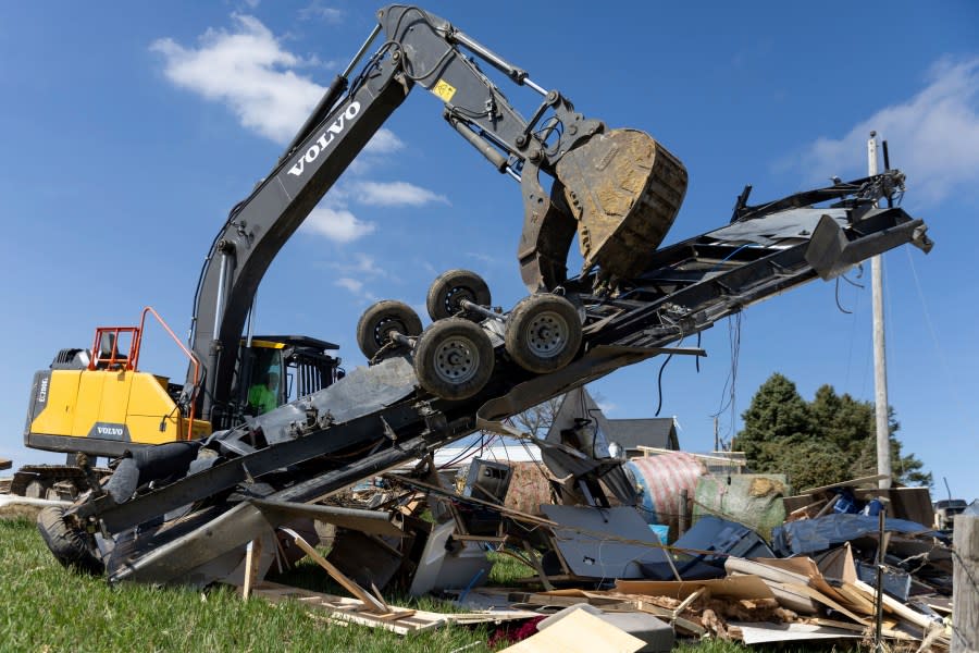 Friends, family and coworkers help clean up the damage, including a destroyed RV, on Jared and Tory Crozier’s property near Minden, Iowa on Saturday, April 27, 2024, after a tornado the previous evening. (Anna Reed/Omaha World-Herald via AP)