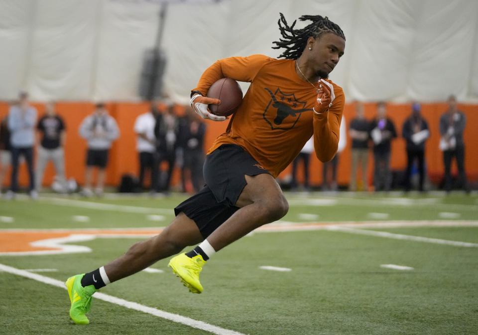 Wide receiver Adonai Mitchell goes through drills at Texas' Pro Day