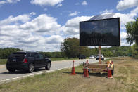 Drivers on Connecticut Route 2, in Preston, Conn., Monday, June 1, 2020, pass one of four electronic signs erected Sunday night by the state to warn patrons of Foxwoods Resort Casino and Mohegan Sun about the potential dangers of being a large crowd and urging them not to "gamble with COVID." Both tribal casinos, closed since March 17, opened despite opposition from Connecticut Gov. Ned Lamont, who has limited power regarding the sovereign nations. (AP Photo/Susan Haigh)