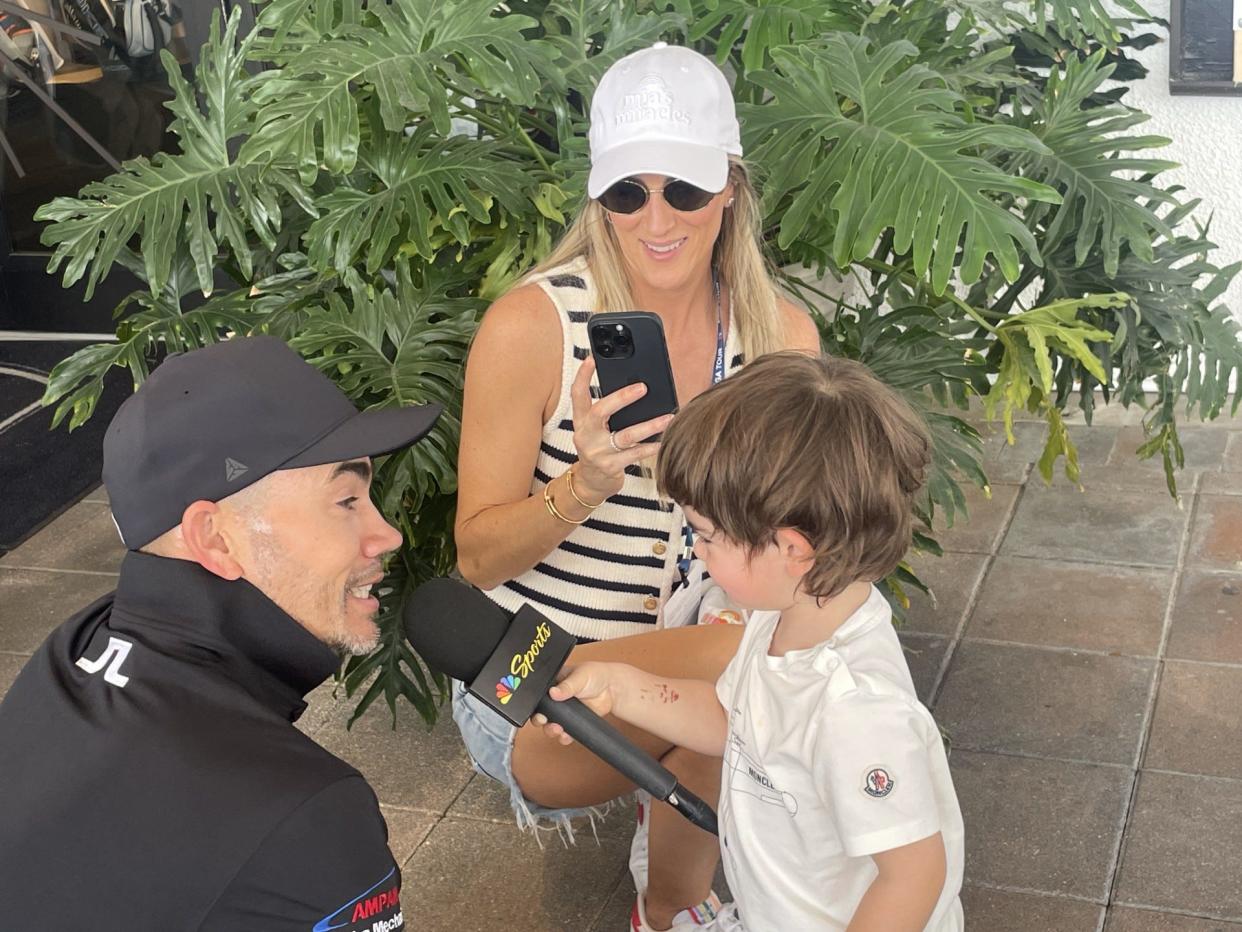 Maria Villegas records her son, Mateo, interviewing her husband, PGA Tour pro Camilo Villegas, at the Cognizant Classic in February.