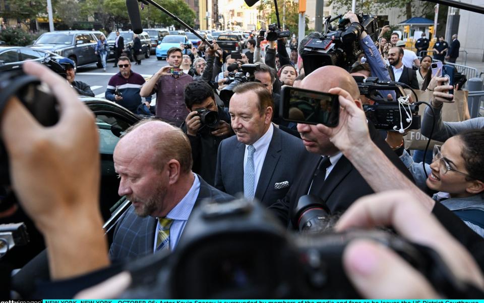 Actor Kevin Spacey is surrounded by members of the media and fans as he leaves the US District Courthouse - Getty