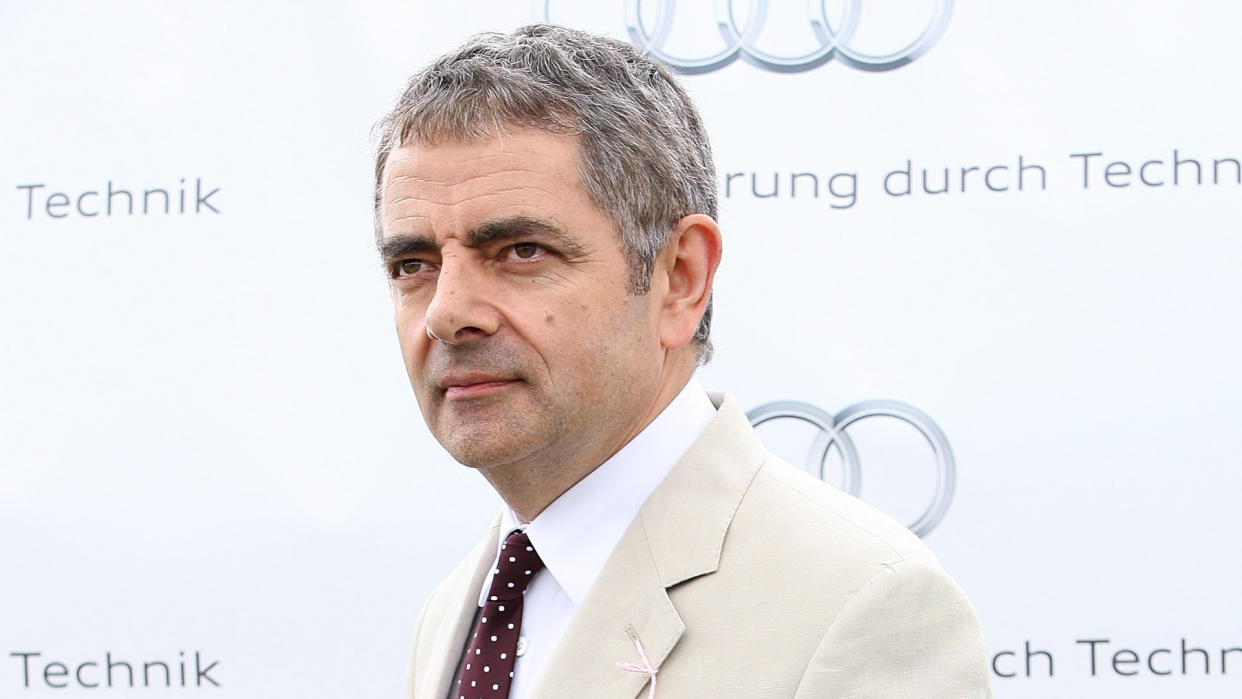 CHICHESTER, ENGLAND - AUGUST 02:  Rowan Atkinson gives an award at ladies day at 'Glorious Goodwood' at Goodwood on August 2, 2012 in Chichester, England.