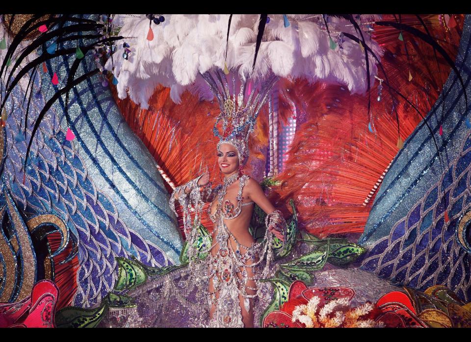 A nomine for Queen of the Santa Cruz carnival shows off her outfit under the watchful eyes of the jury at Santa Cruz de Tenerife on the Spanish Canary island of Tenerife, February 15, 2012. (DESIREE MARTIN/AFP/Getty Images)