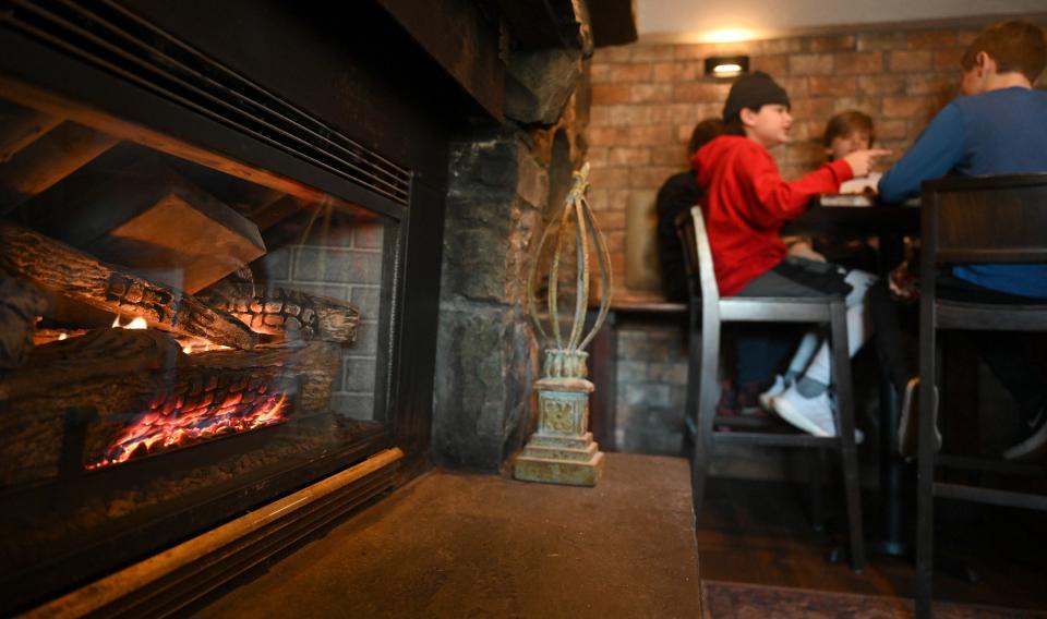 A group of youngsters enjoy lunch by the gas fire at Kennedy's Restaurant, Pub and Market in Marlborough, Jan. 21, 2022.