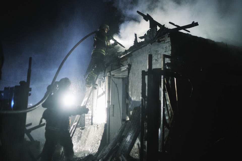 Rescue workers extinguish the fire of a house which was destroyed after a Russian drone strike on residential neighborhood in Kharkiv, Ukraine, on Thursday, April 4, 2024. (AP Photo/George Ivanchenko)