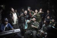 Julius Schrank, a German photographer working for De Volkskrant won 1st Prize Daily Life Single category of the 2014 World Press Photo contest with this picture of Kachin Independence Army fighters drinking and celebrating at a funeral of one of their commanders who died the day before, in Burma, taken March 15, 2013. The prize-winning entries of the World Press Photo Contest 2014, the world's largest annual press photography contest, were announced February 14, 2014. REUTERS/Julius Schrank/World Press Photo Handout via Reuters