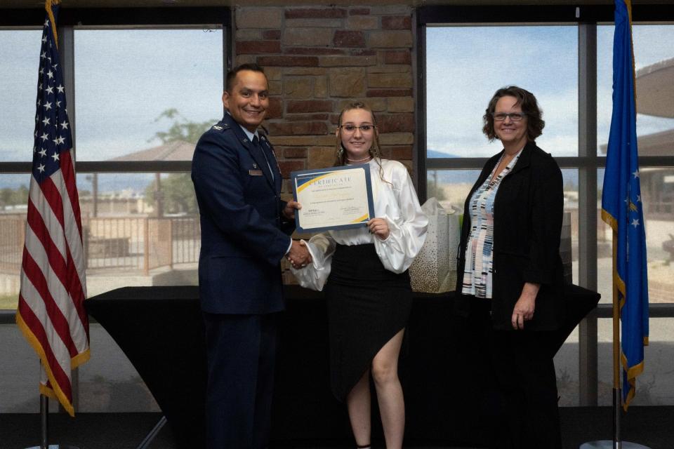 Terrah Rodriguez, Project SEARCH intern, accepts a graduation certificate for completing the Project Search program at Holloman Air Force Base, New Mexico, Thursday May 18, 2023.