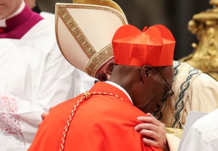 Pope Francis greets Cardinal Jean Zerbo (R) during a consistory as he elevate five Roman Catholic prelates to the rank of cardinal, at Saint Peter's Basilica at the Vatican, June 28, 2017. REUTERS/Alessandro Bianchi