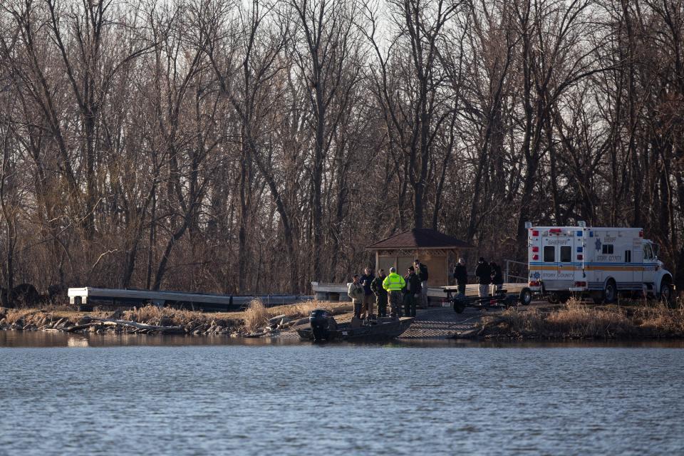 Law enforcement gather near a boat ramp on Little Wall Lake as they resume the search for a missing Iowa State University Crew Club member on Monday, March 29, 2021, in Hamilton County. The ISU student has been missing since the rescue of three other students and the death of one on the lake Sunday. 