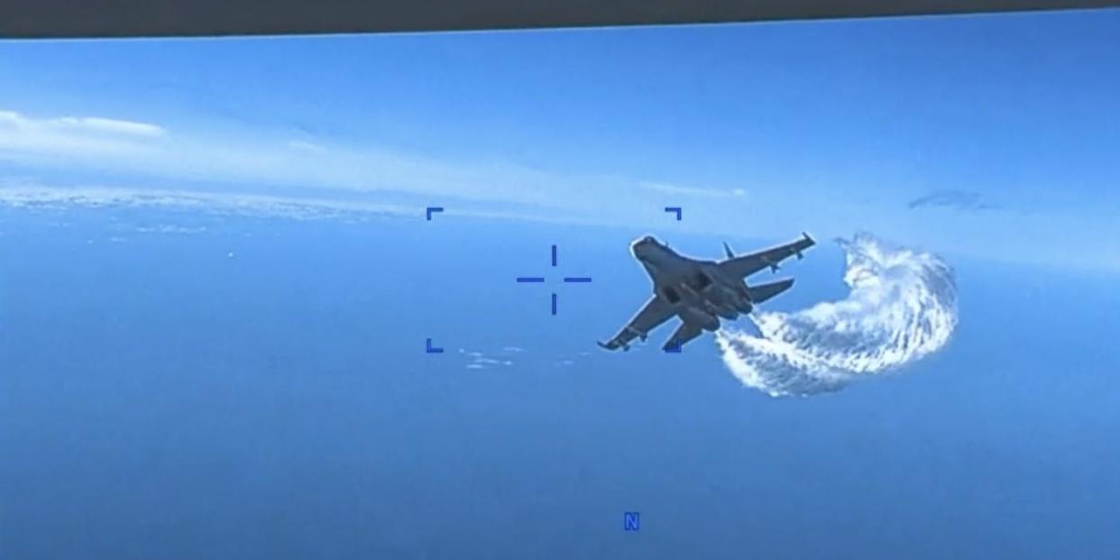 A Russian Su-27 fighter jet approaches a US military MQ-9 Reaper drone operating above the Black Sea on March 14, 2023.