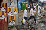 <p>Kenyans walk past election posters in the Kibera slum in Nairobi, Kenya, Monday Aug. 7, 2017. (Photo: Jerome Delay/AP) </p>