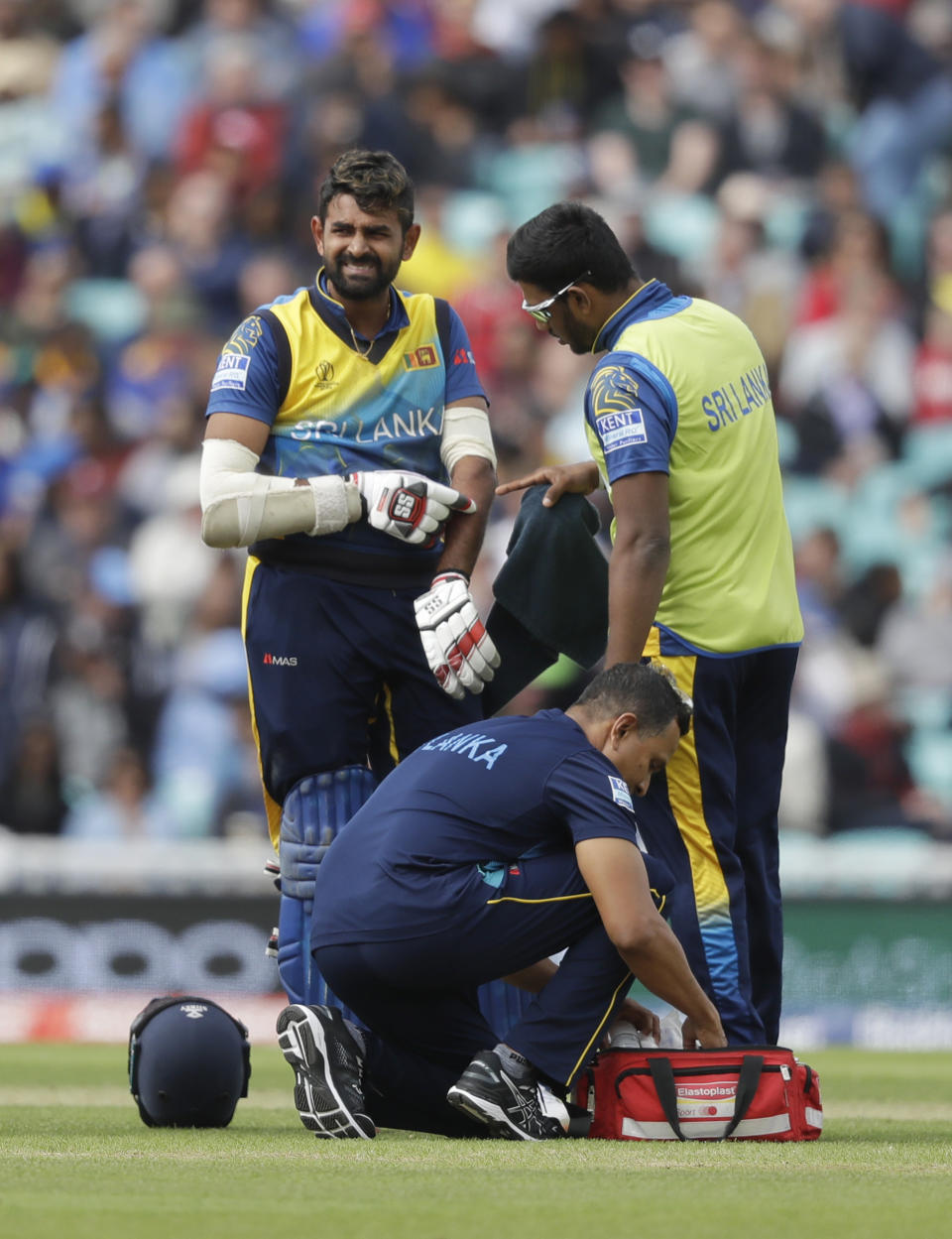 Sri Lanka's Lahiru Thirimanne holds his arm after getting hit by the ball during the World Cup cricket match between Sri Lanka and Australia at The Oval in London, Saturday, June 15, 2019. (AP Photo/Kirsty Wigglesworth)