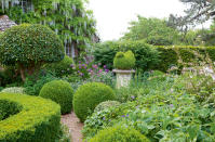 <p> Add a structure to your front garden ideas with striking topiary forms. </p> <p> 'Topiary goes anywhere – it doesn’t matter if your garden’s formal, informal, contemporary or traditional, topiary will slot in effortlessly adding a tailored presence all year round,' says gardening expert Matt James. </p> <p> 'Use its sculptural form as the perfect focal point among frothy perennial plantings spilling with geraniums, penstemons and catmint. Alternatively, for a minimalist style statement try spacing topiary balls or lollipops equidistant apart like soldiers on parade.' </p> <p> Topiary looks particularly architectural when planted in pots. Arrange these in informal groups or plant classic balls, cones and spirals in tall urns either side of the front door for an elegant look. </p>