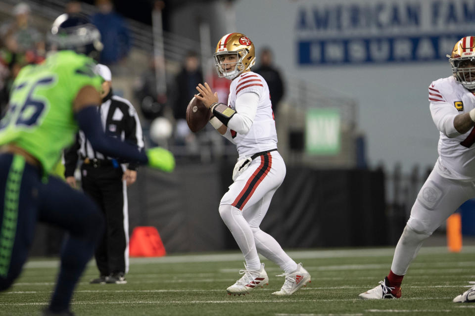 SEATTLE, WA - DECEMBER 15: Brock Purdy #13 the San Francisco 49ers throws for a 54-yard touchdown to George Kittle #85 during the game against the Seattle Seahawks at Lumen Field on December 15, 2022 in Seattle, Washington. The 49ers defeated the Seahawks 21-13. (Photo by Michael Zagaris/San Francisco 49ers/Getty Images)