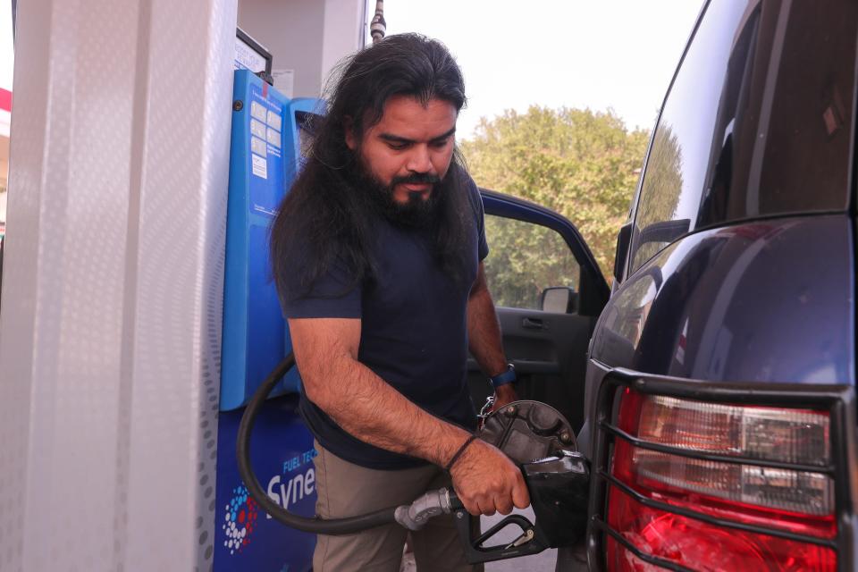 Miguel Arias puts gas in his vehicle Monday at an Exxon station on William Cannon Drive. Arias said he does landscaping for a living and has to buy fuel for his truck and his gas-powered tools. "I have to spend more on fuel, so I have to increase my prices when I go do the jobs. Then the customer is paying more, and it's affecting me because my customers used to call me every two weeks, but now they might call me every four or five weeks."