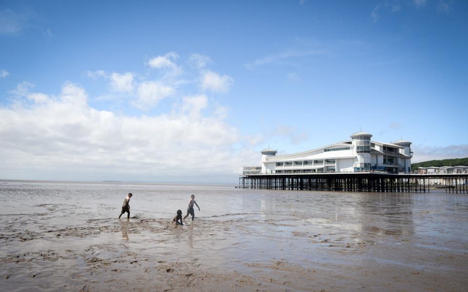 Young boys play in the mud, at Weston-super-Mare beach - Credit: Ben Birchall/PA