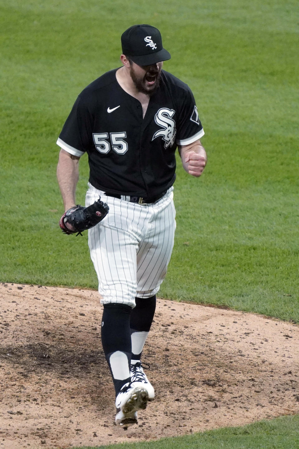 Chicago White Sox starting pitcher Carlos Rodon (55) reacts after striking out Cleveland Indians' Amed Rosario to end the eighth inning of a baseball game, Wednesday, April, 14, 2021, in Chicago. (AP Photo/David Banks)